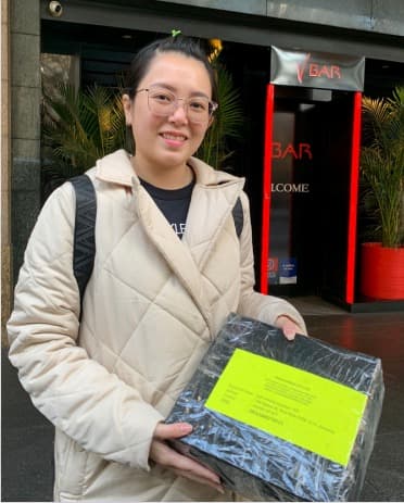 Customer smiling beside their cargo delivery