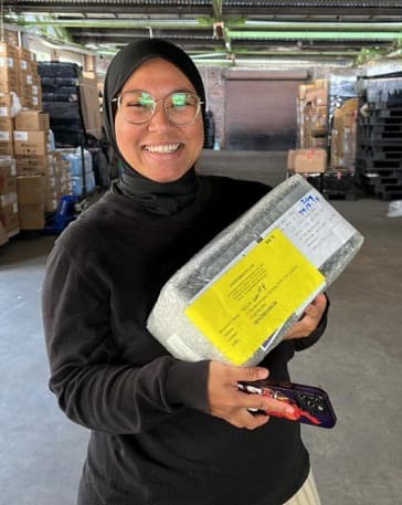 Tech startup team unboxing hardware shipment