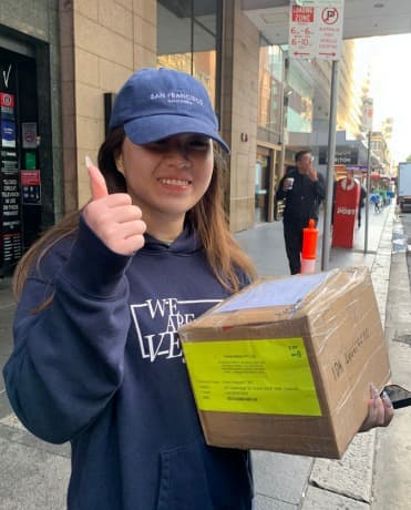 Customer and courier celebrating shipment handoff